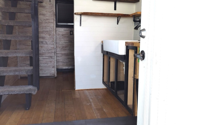 Entry view inside tiny house rental showing loft stairs and open living space Orlando Entry view inside tiny house rental showing loft stairs and open living space Orlando