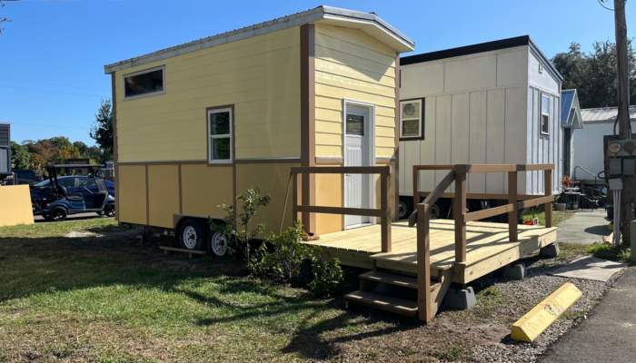 Affordable tiny house rental in Orlando with deck and yellow exterior at Tiny Town Orlando Affordable tiny house rental in Orlando with deck and yellow exterior at Tiny Town Orlando