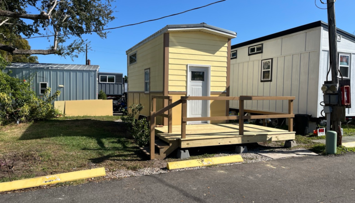 Open layout tiny house interior with stairs to loft and kitchen workspace Open layout tiny house interior with stairs to loft and kitchen workspace