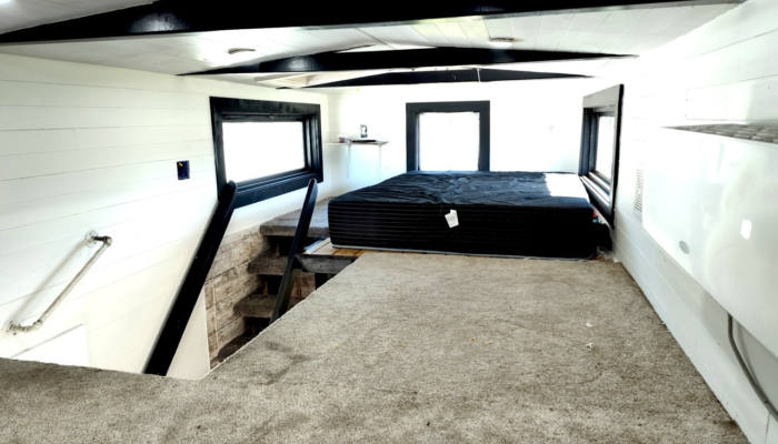 Loft sleeping area in affordable tiny house rental Orlando with windows and beams Loft sleeping area in affordable tiny house rental Orlando with windows and beams