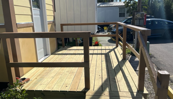 Economical monthly tiny house rental Orlando exterior view with wooden porch and stairs Economical monthly tiny house rental Orlando exterior view with wooden porch and stairs