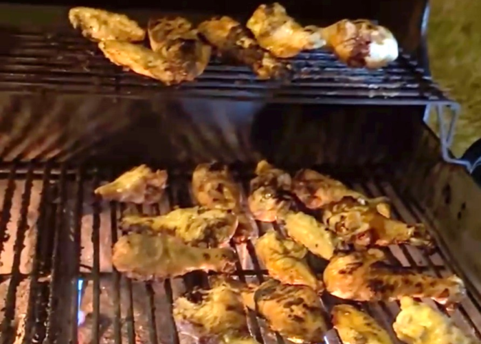Grilled chicken wings cooking over an open flame during Tiny Town Orlando Super Bowl party Grilled chicken wings cooking over an open flame during Tiny Town Orlando Super Bowl party