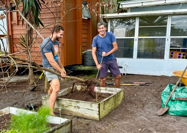 Residents planting a tree during Tiny Town Orlando community garden project Residents planting a tree during Tiny Town Orlando community garden project