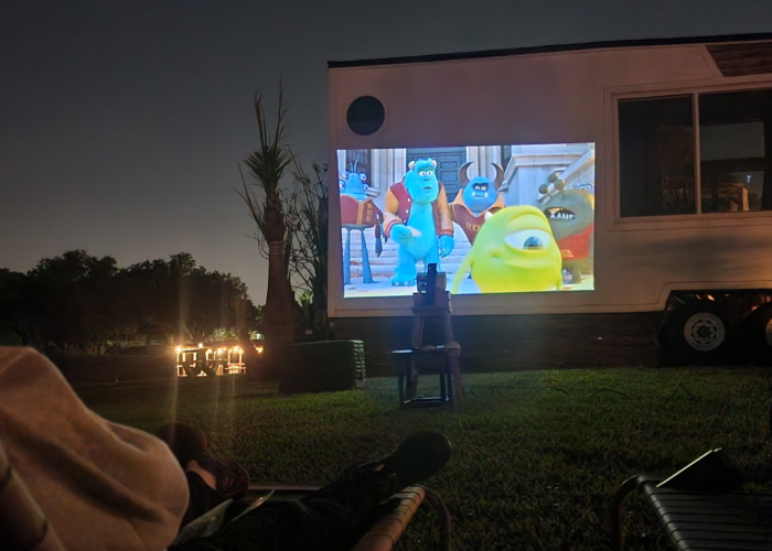 Outdoor movie night at Tiny Town Orlando tiny home community with projector and lounge seating under the stars Outdoor movie night at Tiny Town Orlando tiny home community with projector and lounge seating under the stars