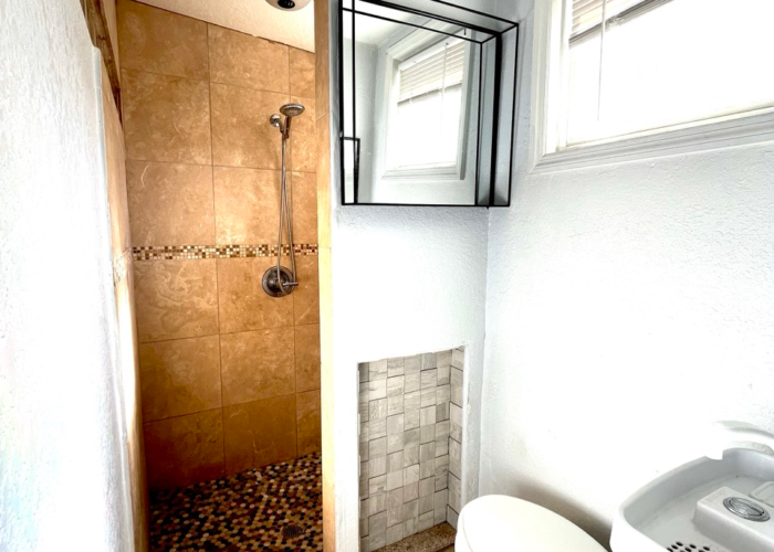 Compact bathroom and tiled shower at the Smurf studio apartment Compact bathroom and tiled shower at the Smurf studio apartment