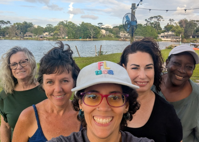 Tiny Town Orlando residents enjoying lakefront community living near Lake Fairview with outdoor social gathering Tiny Town Orlando residents enjoying lakefront community living near Lake Fairview with outdoor social gathering