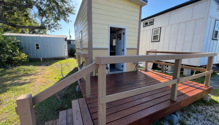 Economical monthly tiny house rental Orlando exterior view with wooden porch and stairs Economical monthly tiny house rental Orlando exterior view with wooden porch and stairs