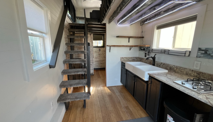 Entry view inside tiny house rental showing loft stairs and open living space Orlando Entry view inside tiny house rental showing loft stairs and open living space Orlando